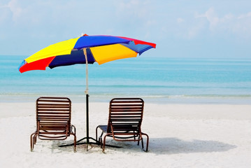 sand beach with chairs and umbrella