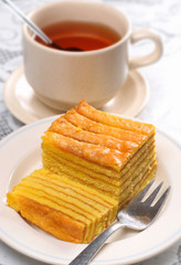 Traditional indonesian bali layer cake with tea at back ground