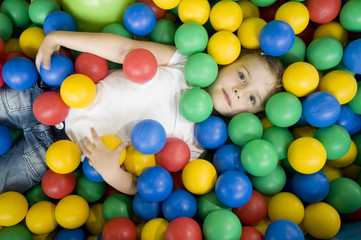 Fototapeta na wymiar Little girl in colorful balls
