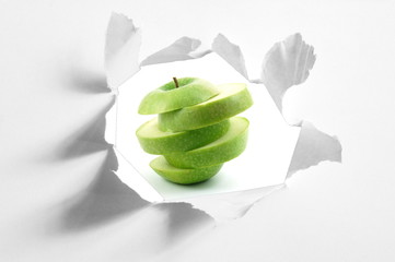 sliced apple and hole in paper