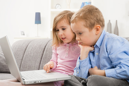 Serious children with laptop