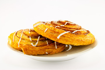 Two Cinnamon Buns on a White Plate