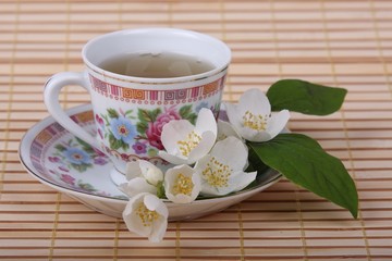 Cup of tea with jasmine flowers