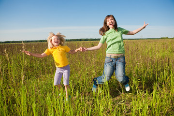 Fototapeta premium Happy mother and daughter at field