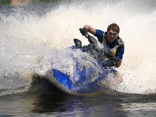 Fotobehang Man on jet-ski turns very fast with diving © Crok Photography