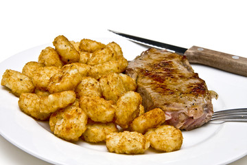 Steak and Potato Buds on White Plate