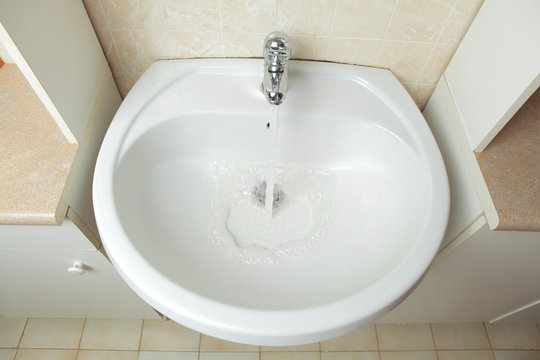 washbowl with water in the bathroom