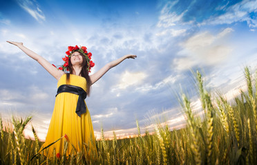Beautiful young girl in the wheat field