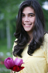 Teen girl standing with tulips