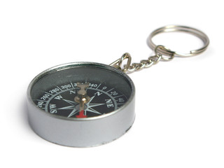 Silver compass keyring on white background