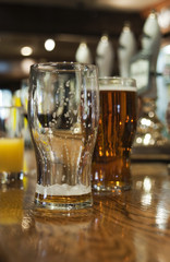 Drinks on bar in a public house, England.