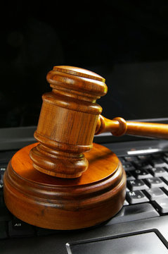 judges court gavel on top of a laptop PC keyboard