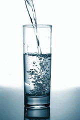 glass of pouring water with reflection