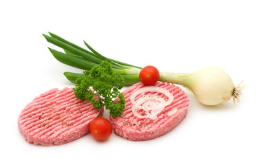 two raw minced beef steak and vegetables