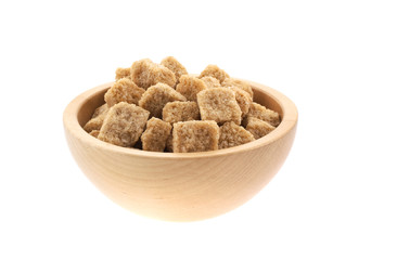 brown sugar cubes in a wood bowl