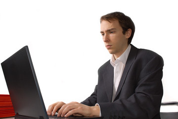 Concentrated young man works on laptop