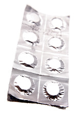 Pills in foil pack over white background