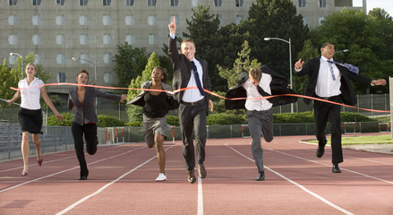 Group of Business People Sprinting Across the Finish Line