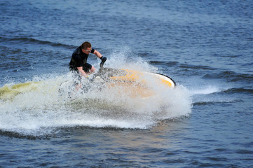 Young man riding jet ski