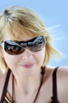Attractive young woman wearing sunglasses