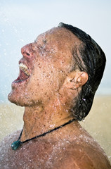 man washing under the shower.