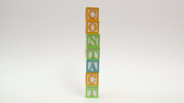 Wooden alphabet blocks spell out CONTACT