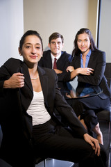 Three smiling businesspeople in a meeting