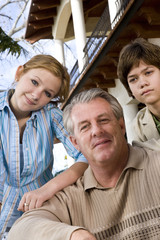 Close-up portrait of father with daughter and son
