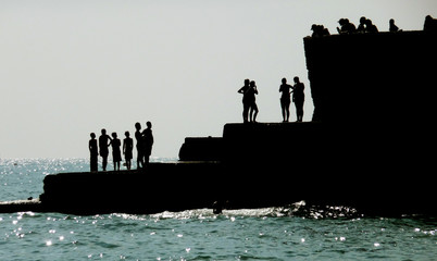Silhouetted People On Brighton Coast
