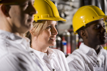 Close up of coworkers wearing hard hats