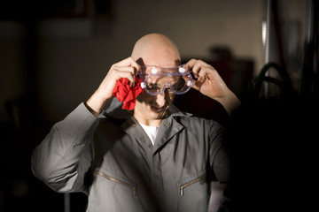 Close up of man donning protective eyewear