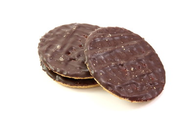 Three chocolate biscuits on white background.