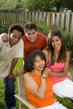 Interracial family relaxing in back yard