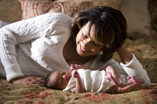 African American Mother Admiring Her Newborn Child