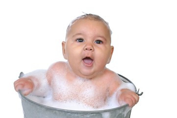 six-month-old baby girl in bubble bath, isolated on white