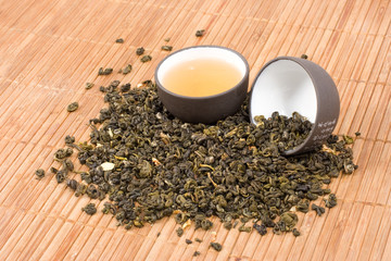 Two cups with dry herbal tea.