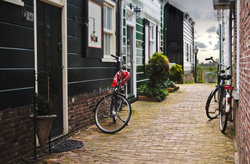 Narrow alley with bikes parked at village at Holland.