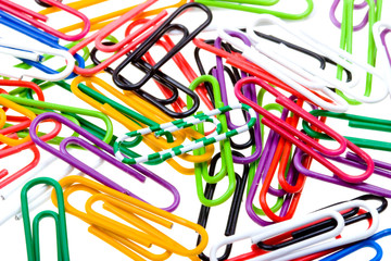 Color paper clips to background. Isolated on white
