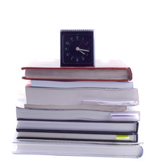 clock on a pile of books