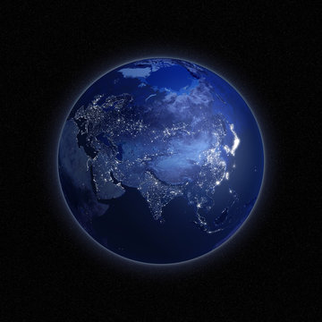 Night view of the Earth with lights glowing in urban areas.