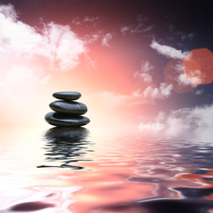 Fototapeta na wymiar Zen stones reflecting in water background