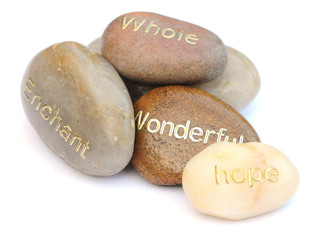 words on pebbles on white