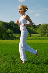 Beautiful young woman running outdoors