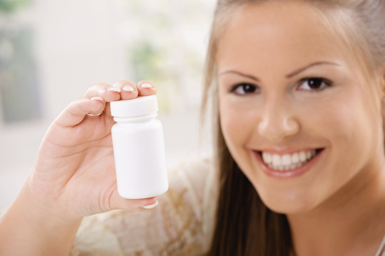 Woman showing pill bottle