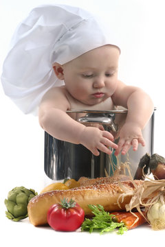 Cute Chubby Baby Chef in a Cooking Pot Looking Downwards