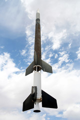 An Old Rocket Against a Cloudy Blue Sky