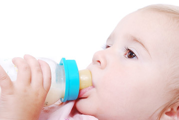 Adorable baby with milk bottle
