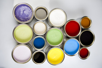 Cans and paint on the colourful background