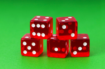 Red dice against green background
