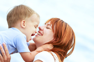 outdoor portrait of happy mother and son